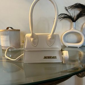 Mini white jacquemus bag. Price reflects